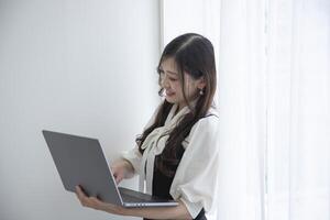 A working Japanese woman by remote work in the home office closeup photo