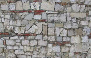 Old wall stone texture and background with rustic tiles design photo