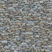 Old wall stone texture and background with rustic tiles design photo