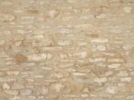 Old wall stone texture and background with rustic tiles design photo