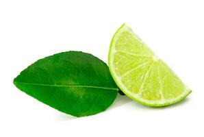 Front view of green lemon slice or quarter with leaf isolated on white background with clipping path photo