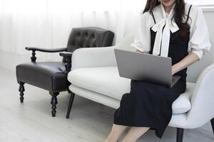 A Japanese woman typing laptop by remote work in the office faceless composition photo