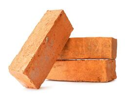 Cracked old red or orange bricks in stack isolated on white background with clipping path photo