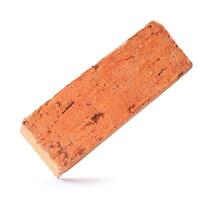 Single cracked old red or orange brick isolated on white background with clipping path photo