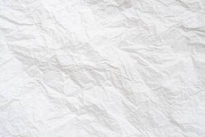 Wrinkled or crumpled white stencil or tissue paper used for crumpled paper background texture. photo