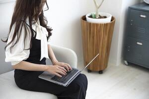 A working Japanese woman by remote work in the home office closeup photo