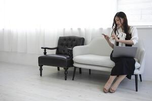 A Japanese woman checking smartphone by remote work in the home office photo