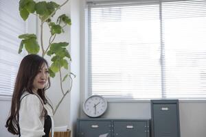 A working Japanese woman by remote work in the home office closeup photo