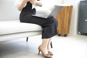 A Japanese woman checking smartphone in the home office faceless composition photo