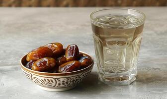 AI generated A glass of water beside a bowl of dates, islamic traditional clothing concept photo