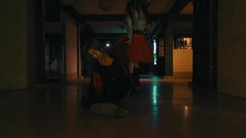 Silhouette of a person walking in a dark, moody corridor with subtle light reflections on the floor. video