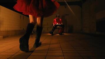 Silhouette of a person walking in a dimly lit tunnel with a red light in the background, creating a mysterious atmosphere. video