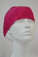 Bathing cap female pink on a mannequin in the trading floor of the store. Cap for swimming in the pool and on the beach. photo