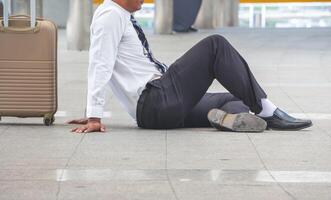 Lonely businessman lost in a depression sitting on the floor, feeling sad concepts photo