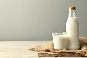 ai generado botella de Leche y vaso con avena copos en de madera mesa. foto