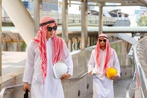 Muslim engineer man checking project at building site, Arab Middle Eastern businessman with a blueprint in construction site photo