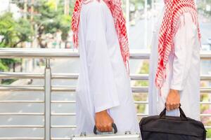 Arab businessman walking outside office, business man is walking through the city street photo