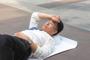 Engineer man relaxing lying and sleeping on the floor after working hard photo