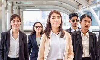 Group of happy young business team, businesspeople walking the outdoor office together success teamwork for concepts photo