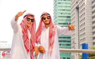 Young Arab Middle Eastern businessman team showing thumbs up as a sign of success business photo