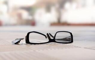 a broken eyeglass frame lies on a street ribbed tile a sunny day. High quality photo