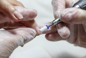 hands of the master in the beauty salon doing manicure to the client. selective focus.High quality photo