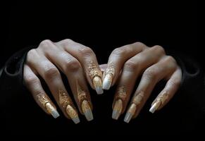 AI generated a woman's black and gold manicured hands with white nails on a black background photo