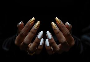 AI generated a woman's black and gold manicured hands with white nails on a black background photo