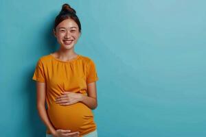 AI generated Pregnant Asian woman keeps hand on belly. stands thoughtfully against blue background photo