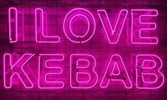 Neon shining sign in pink or purple color on a brick wall with the inscription or slogan I love kebab. Brick wall, background. Bright electric neon light. Cafe-restaurant Doner Kebab. photo