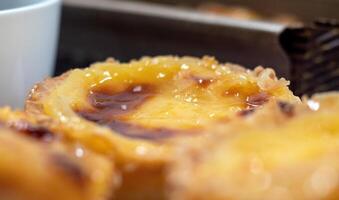 Lots of freshly baked desserts Pastel de nata or Portuguese egg tart. Pastel de Belm is a small pie with a crispy puff pastry crust and a custard cream filling. A small dessert, a cupcake. photo
