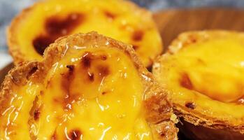 Lots of freshly baked desserts Pastel de nata or Portuguese egg tart. Pastel de Belm is a small pie with a crispy puff pastry crust and a custard cream filling. A small dessert, a cupcake. photo