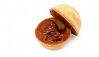 Halves of fresh and tasty cookies in the shape of a walnut with boiled condensed milk on a white background. A favorite delicacy for children and adults with a delicate filling inside. photo