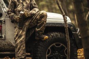 Animal Hunter Staying Next to His AWD Vehicle photo