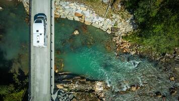 Camper Van on a River Bridge Aerial View photo