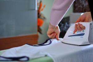 Woman hand ironing photo