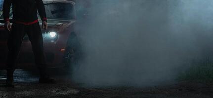 Muscle Car and a Driver Covered by Smoke After Heavy Burnout photo