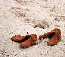 Abandoned boots on beech photo