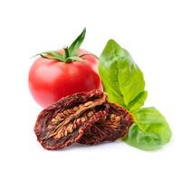 Tomatoes vegetables with dried tomato with basil leaveson white backgrounds. Healthy food photo