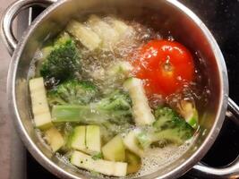 Fresh vegetable soup in a saucepan. Vegetable broth. photo