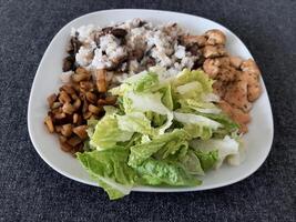 Homemade grilled chicken with grilled chopped eggplant, green salad, and rice Pilaf with mushrooms photo