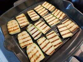 Grilled zucchini slices in cast iron pan photo