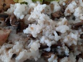 Homemade meal. Rice pilaf with mushrooms details on a plate photo