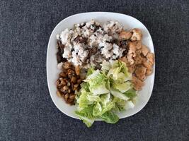 Homemade grilled chicken with grilled chopped eggplant, green salad, and rice Pilaf with mushrooms photo