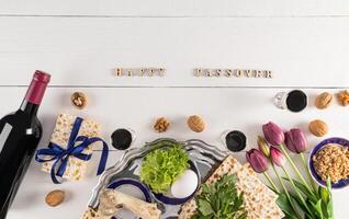 Festive background for Jewish Passover holiday with traditional food and symbols. The concept of the Passover. Top view. Text of Happy Passover. photo