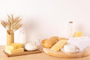 Dairy products and bread over wooden background. Symbols of Jewish holiday - Shavuot. Front view photo