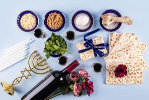 Beautiful festive background for the holiday of Jewish Passover. Traditional kosher treats and symbols on a blue background. Flat lay. Top view. photo