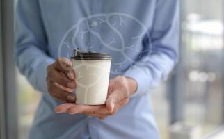 Close-up shot of Barista holding coffee cup take away in hand. photo