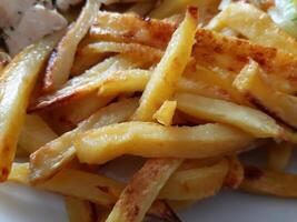 French fries served on the plate. Close up details photo