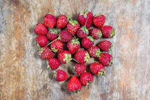 Strawberry heart shape design on wooden table - Concept Valentine Day photo